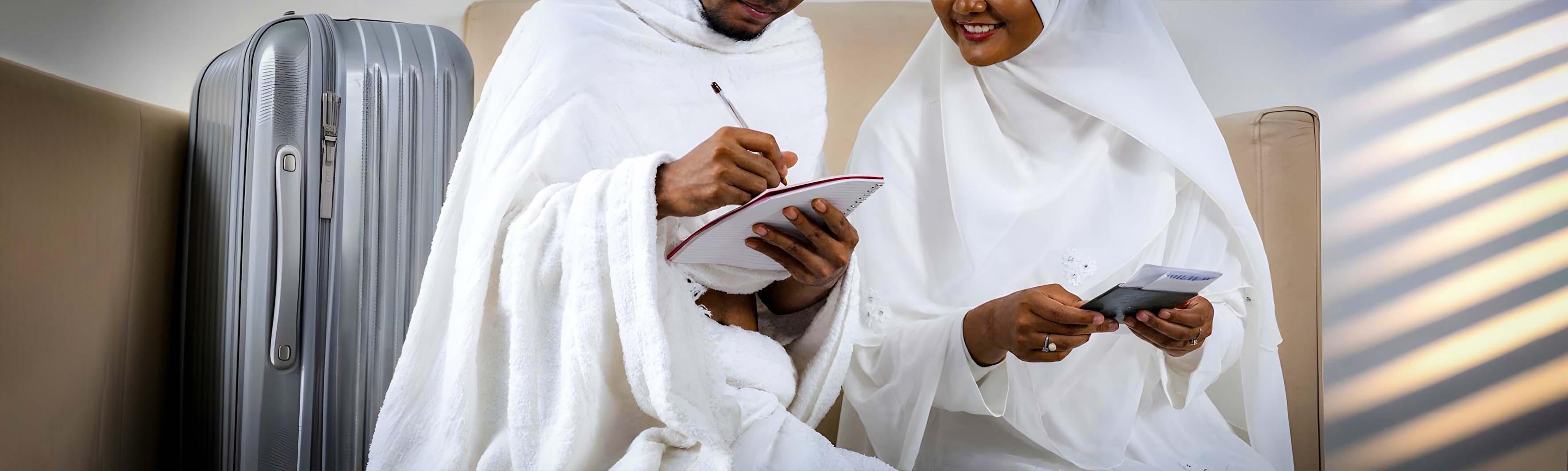 Pilgrims preparing travel items for Hajj and Umrah